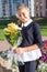 Preteen Russian schoolgirl with beautiful flowers, portrait in uniform, ready to go back to school