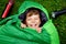 Preteen school kid boy in sleeping bag camping. Outdoors activity with children in summer. Fun and adventure camp