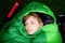 Preteen school kid boy in sleeping bag camping. Outdoors activity with children in summer. Fun and adventure camp