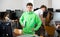 Preteen schoolboy with workbooks in hands standing in computer class