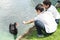 preteen schoolchildren feeding swan