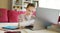 Preteen schoolgirl doing her homework with laptop computer at home. Child using gadgets to study. Online education and distance