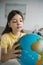 preteen schoolgirl looking at blurred globe