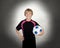 Preteen with a uniform for play soccer holding a ball