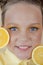 preteenager girl with lemon on yellow background. child with fruit