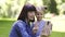 Pretty 30-aged happy mother with her daughter taking selfie picture in the park, smiling and having fun, showing victory