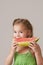 Pretty 5 year old girl eating watermelon