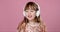 Pretty 6 or 7 years old little girl singing and dancing with headphones
