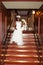 Pretty african american bride holding flowers on stairs indoor