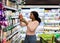 Pretty African American woman choosing groceries at supermarket, shopping for food, buying products for her family