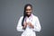 Pretty african american woman intern nurse isolated on gray background