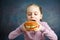 Pretty American Little Girl Eating Burger. Unhealthy Eating Concepts. Posing In Indoors In Studio