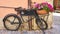 Pretty Artistic Street Scene of an antique bicycle with lovely flowerpot filled with flowers built in