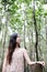 Pretty Asain girl is smiling and sitting on wooden bridge in the tropical mangrove forest at Thailand