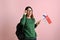 Pretty Asian female college student holding the flags of Finland and Singapore