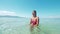 Pretty asian girl in ocean bathing and swimming at sunny day on Philippines.