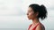 Pretty asian woman doing yoga on the ocean coast. Young woman practicing morning meditation in nature at the beach. Girl