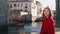 Pretty asian woman enjoying the river view from Italian bridge in Venice. Happy female tourist during the summer