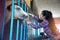 Pretty Asian woman petting horse in a farm.