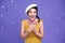 Pretty asian woman smile  welcoming the new year 2021with silver confetti party on bright purple background