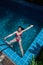 Pretty Asian woman wearing red bikini swim and standing at stair at swimming pool.