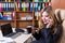 Pretty attractive happy woman in suit in office talking on mobil