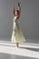 Pretty ballerina in dress spinning on