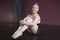 Pretty ballerina sitting and smiling at camera