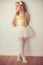 Pretty ballet child girl in white tutu staying