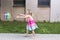 Pretty barefoot little girl throwing multicolored beach ball