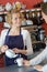 Pretty barista smiling serving tea