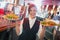 Pretty barmaid holding plates of salads