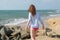 Pretty beautiful young european woman walking towards ocean on the beach