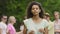 Pretty biracial woman looking into camera, smiling. Group of friends at party