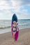 Pretty blond girl model like Marilyn Monroe with surfing board on a beach