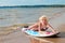 Pretty blond girl model like Marilyn Monroe with surfing board on a beach