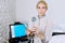 Pretty blond woman doctor cosmeolotgist and beautician holding a tool for Mesotherapy LED Photon Light Therapy RF Skin