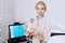 Pretty blond woman doctor cosmeolotgist and beautician holding a tool for Mesotherapy LED Photon Light Therapy RF Skin