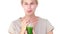 Pretty blond woman drinking vegetable juice