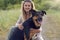 Pretty blond woman with her two dogs crouching