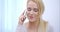 Pretty blond woman listening to a mobile call