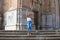 Pretty blonde adult woman dressed in jeans and white top having fun posing for photos on the steps of the cathedral in Cadiz,