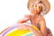 Pretty blonde caucasian female stands in swimsuit with big rubber beach colourful ball, lolipop and smiles isolated on