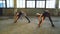 Pretty blonde dancers stretching in old factory building