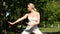 Pretty blonde doing tai chi in the park