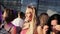 Pretty blonde female with pink top slowly dances near other brunette cute girl.