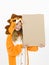 Pretty blonde girl with cozy lion costume is holding a brown sign in the studio in front of white wall