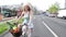 Pretty blonde girl riding bike on the road, looking happy