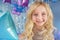 Pretty blonde little girl with color balloons