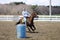 Pretty blonde teenage girl barrel racing